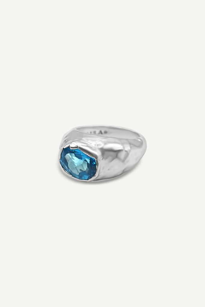 Close-up of Alula Luxe Swiss Blue Topaz ring with textured silver band Front by Alula Collections