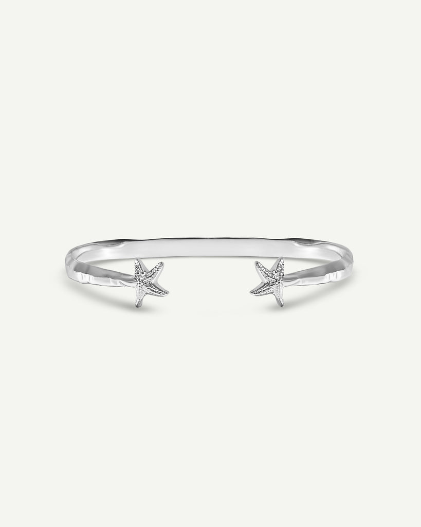 Close-up of handmade sterling silver bangle with starfish detailing front by Alula Collections