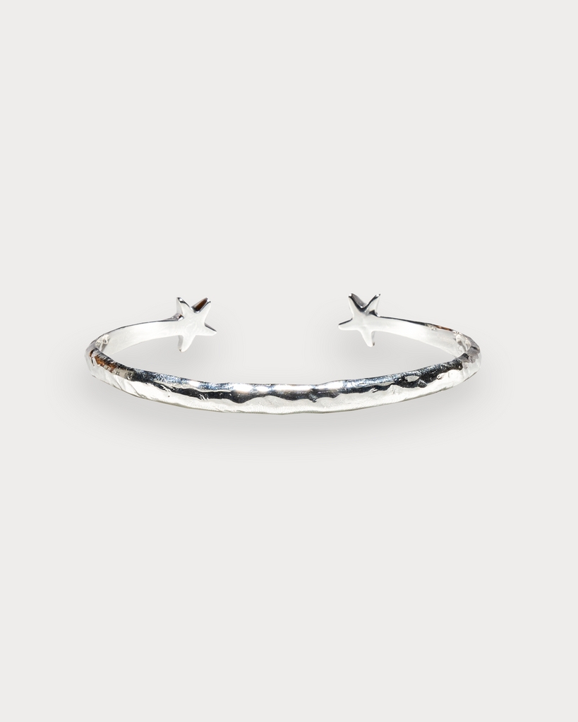 Close-up of handmade sterling silver bangle with starfish detailing back by Alula Collections