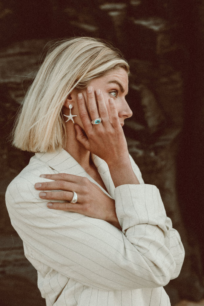 Artisan-crafted silver ring with oval-cut blue topaz from Alula Jewellery.